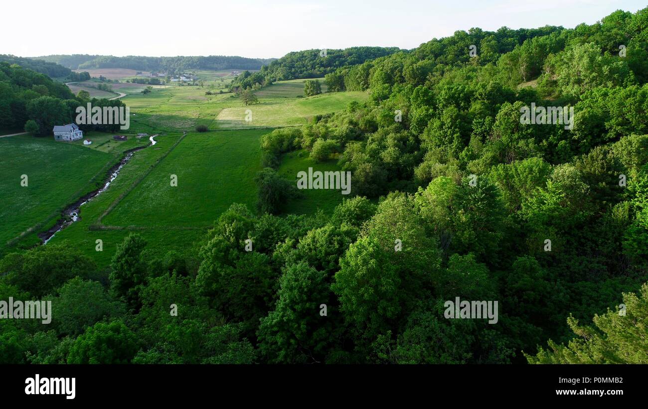 Aerial landscape of lush green forested valley with stream and fields of crops in rural countryside outside Hillsboro, Wisconsin, USA. Stock Photo