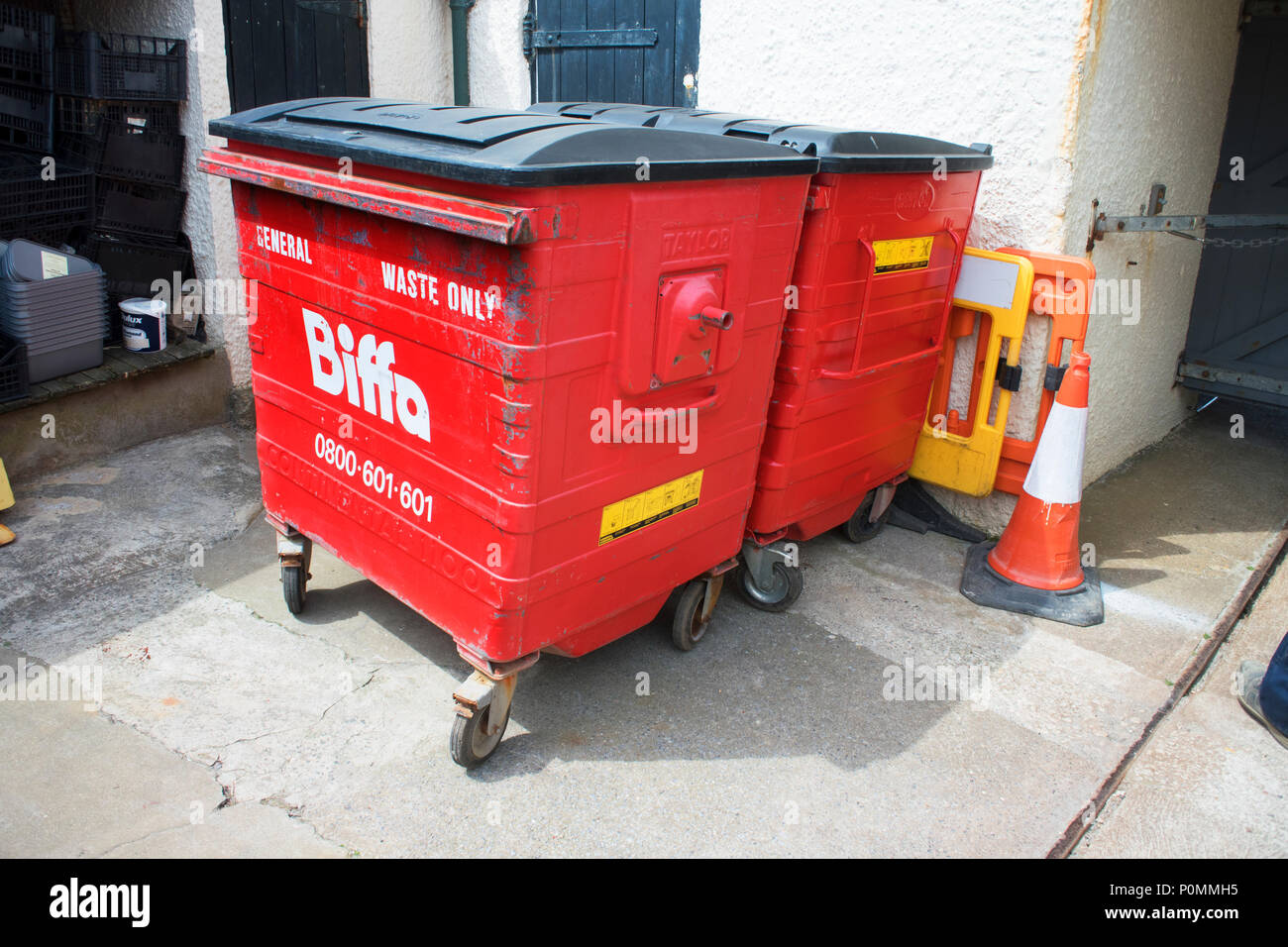 Red industrial wheelie bins at a recycling centre - John Gollop Stock Photo