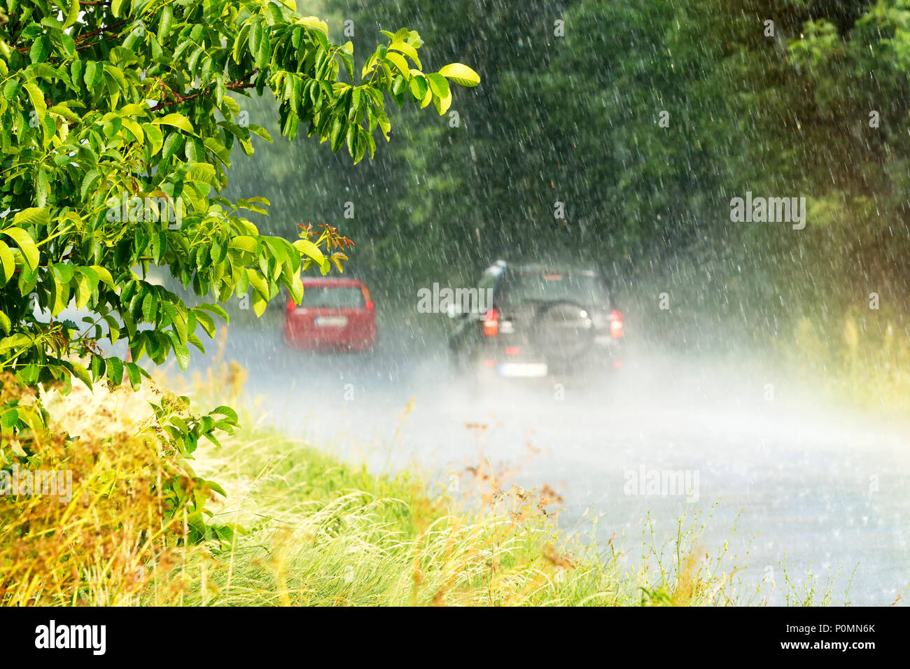 Heavy rain in summer time with rainbow Stock Photo