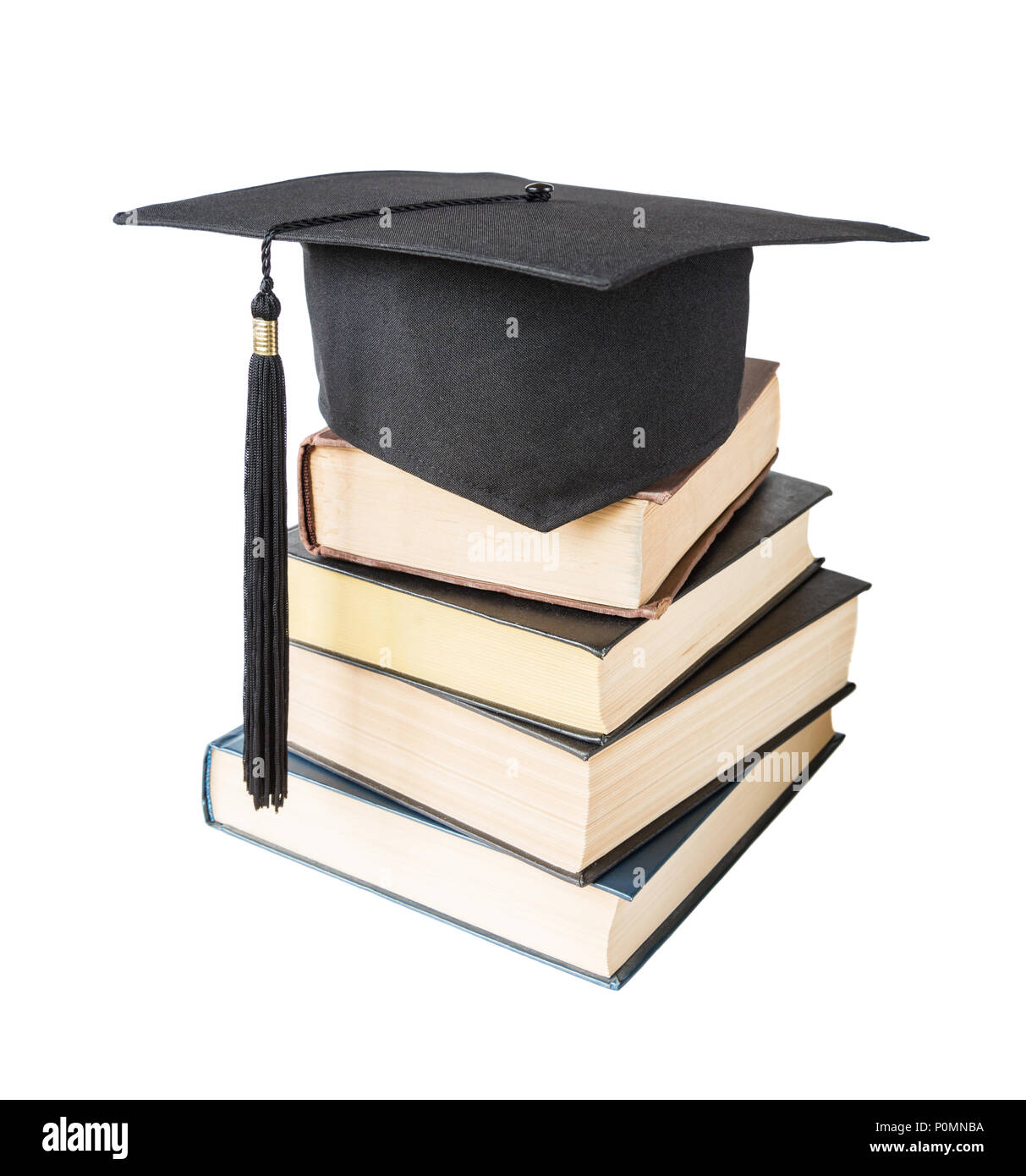 Black graduate (academic) hat on the stack of big books, isolated on white background Stock Photo