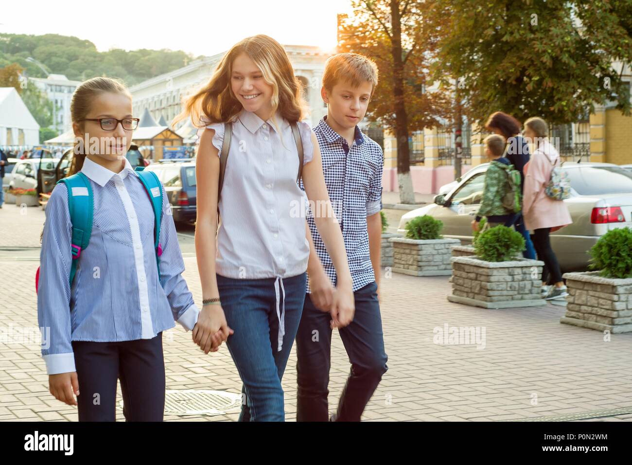 Children go to school holding hands Stock Photo - Alamy