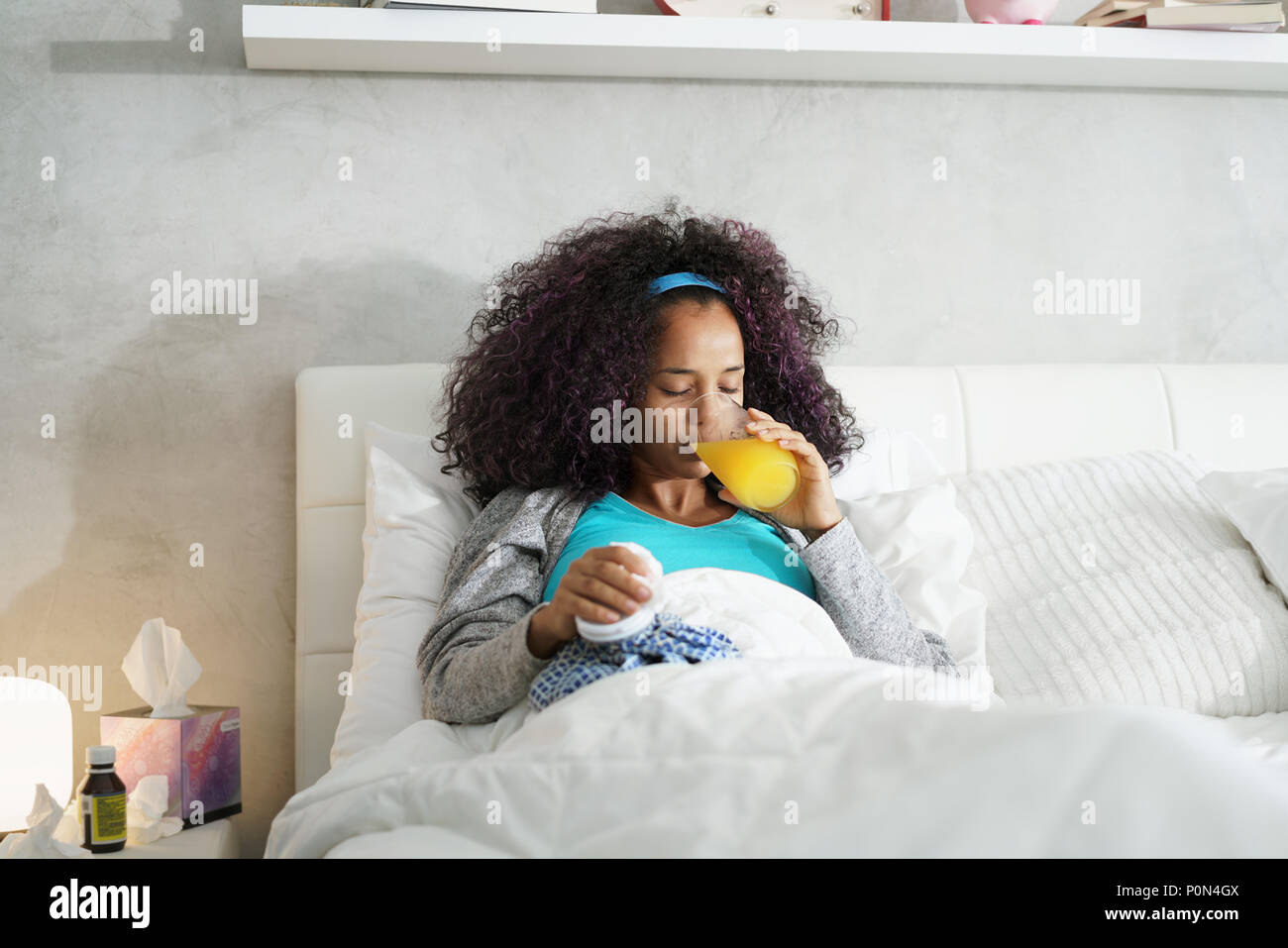 Black Woman With Flu And Cold Holding Ice Bag Stock Photo