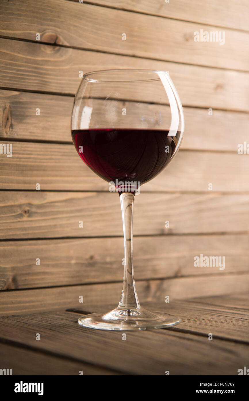 Photo of glass of wine on wooden background. Stock Photo