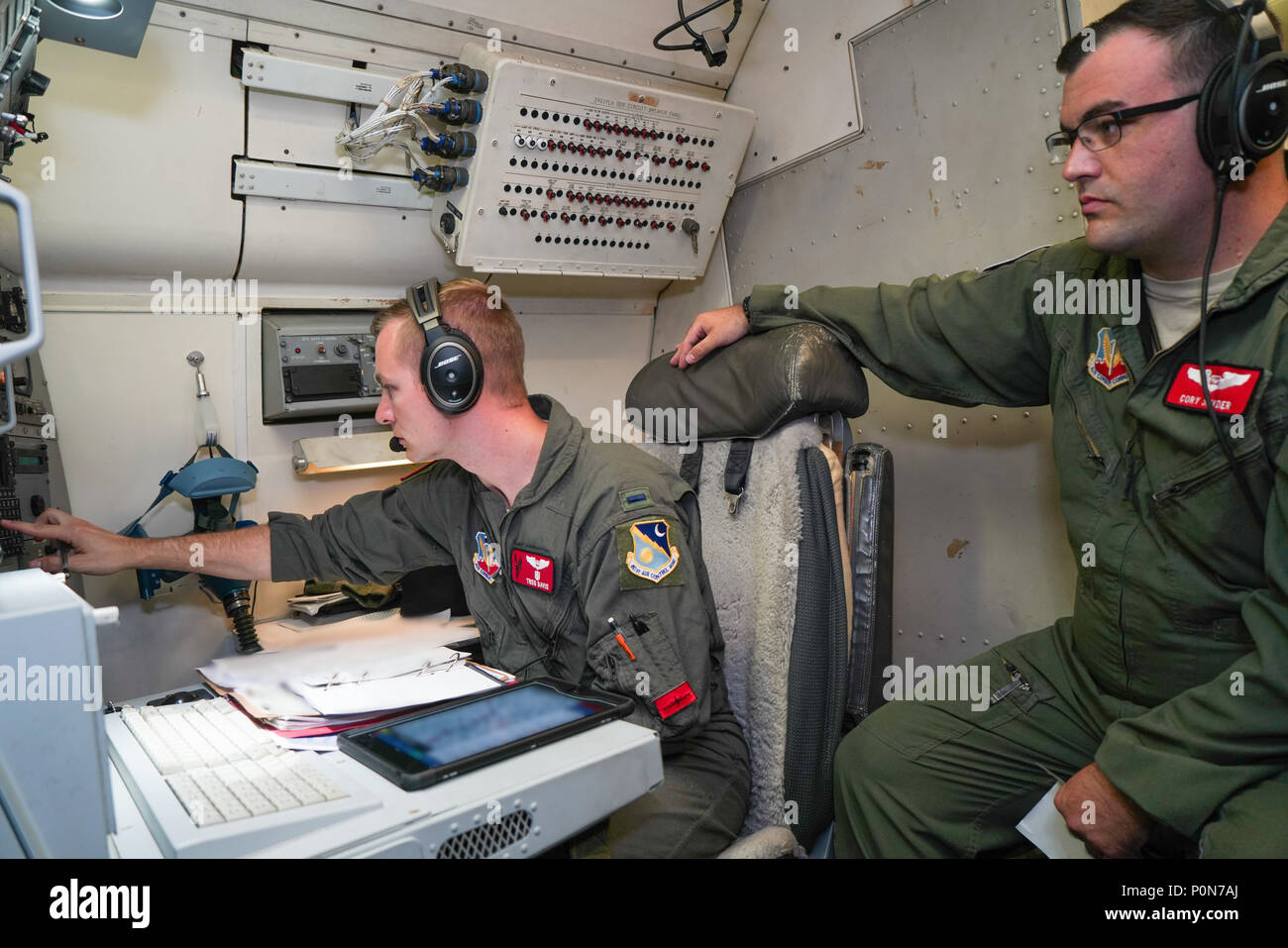 U.S. Air Force 1st Lt. Treg Davis, left, a navigator with the 461st Air Control Wing (ACW), inputs flight information under the watchful eye of Capt. Cory Snyder, a navigator instructor with the 461st ACW, during a mission aboard an E-8C Joint STARS participating in BALTOPS and Saber Strike 18 exercises at Fighter Wing Skrydstrup, Denmark, June 5, 2018. The JSTARS team consists of the Georgia Air National Guard’s 116th ACW, plus active duty personnel assigned to the 461st ACW and Army JSTARS. They are in Denmark to participate in Exercise Baltic Operations, or BALTOPS, June 4-15 and Saber Stri Stock Photo