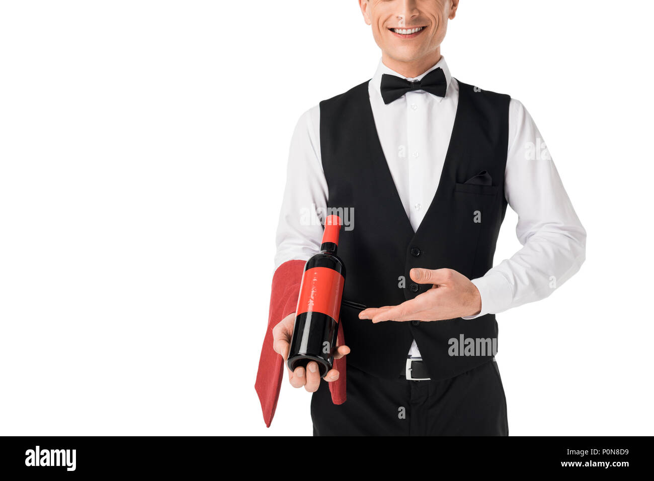 Smiling professional waiter presenting wine bottle isolated on white Stock Photo