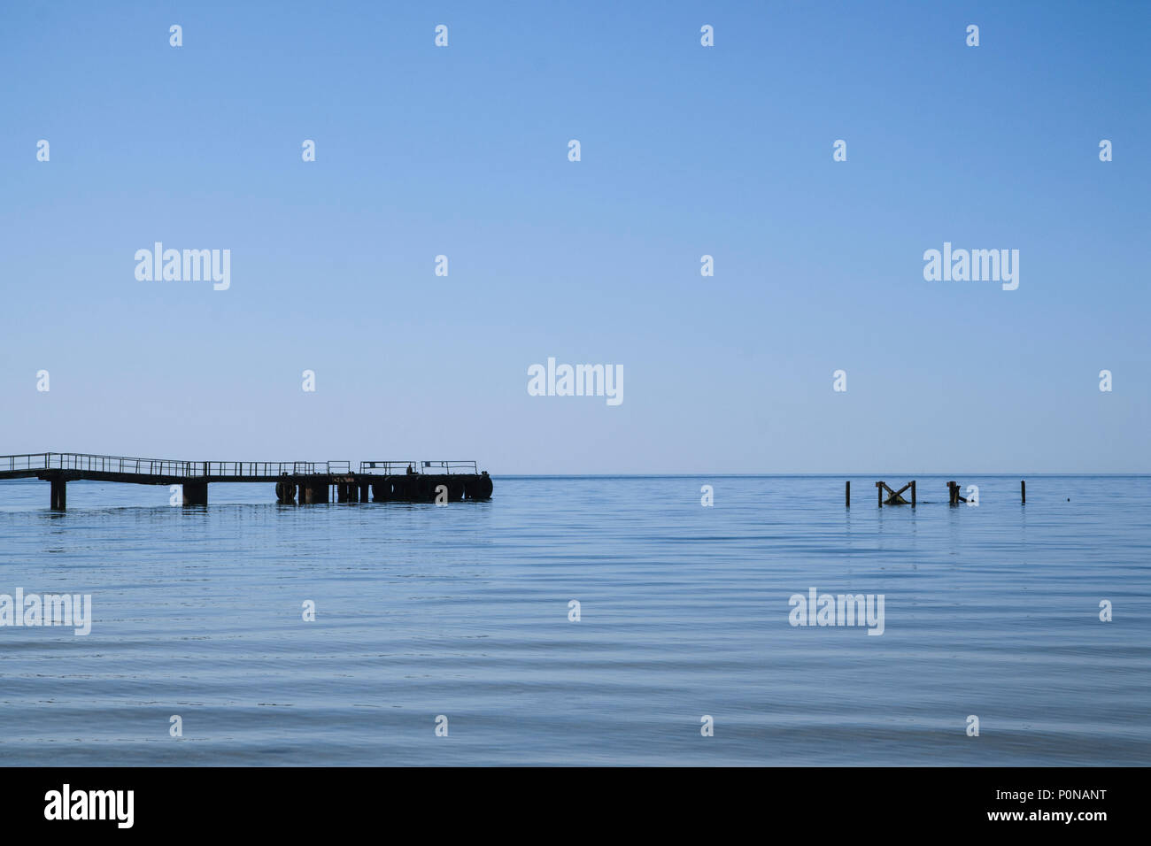 Blue sea. Blue sky. Some architectural objects in the water. Calm and minimalism composition Stock Photo