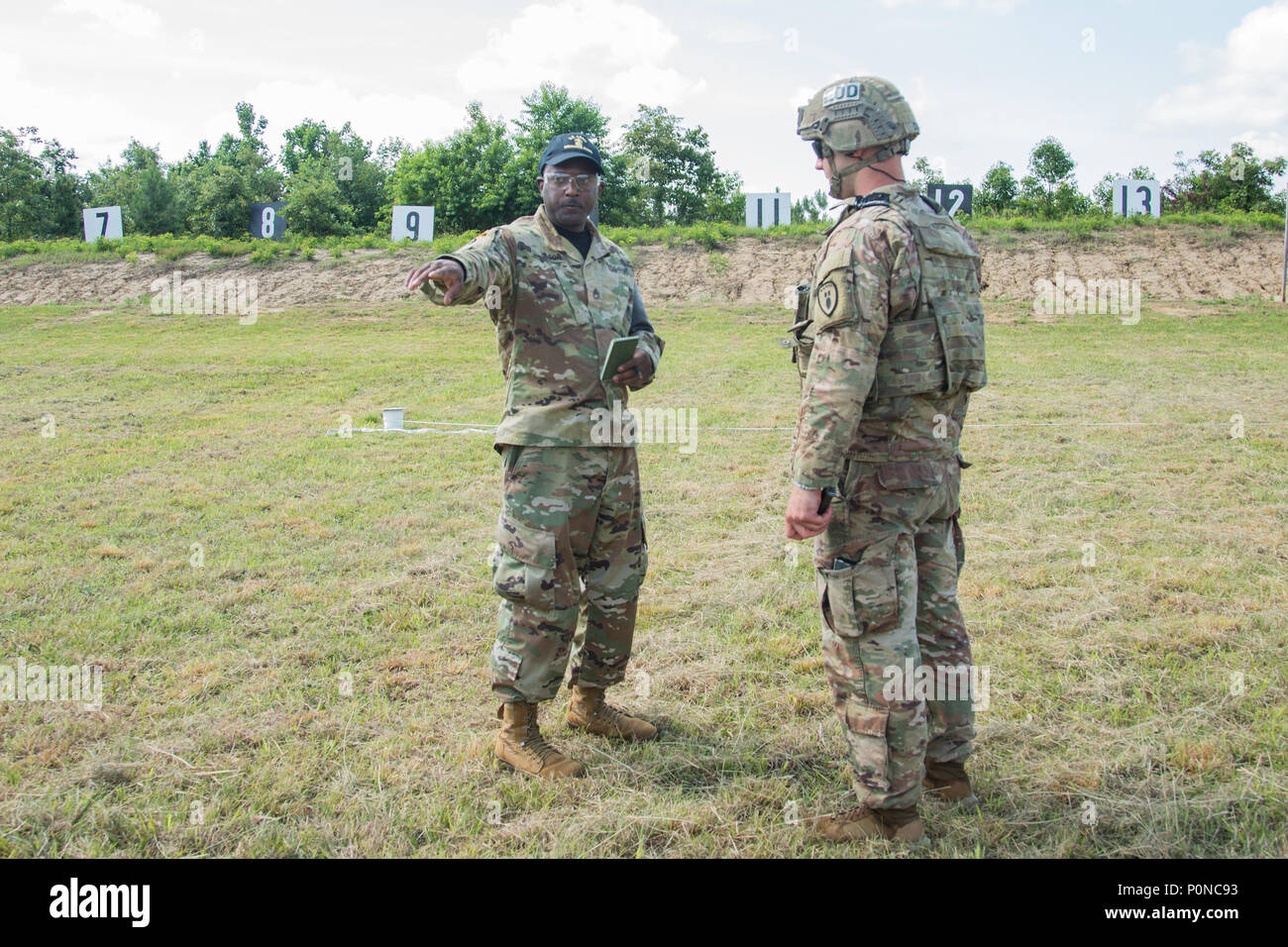 A range control cadre of the Ordnance Crusible 2018 briefs Spc. Barry Craig, an explosive ordnance disposal team member with the 704th Ordnance Company (EOD) from Fort Hood, Texas, during the barrier shoot on June 7, 2018. EOD teams are assessed on operations and associated tasks required to provide EOD support to unified land operations to eliminate and/or reduce explosive threats. The Ordnance Crucible is designed to test Soldiers’ teamwork and critical thinking skills as they apply technical solutions to real world problems improving readiness of the force. (U.S. Army photo by Spc. Shekinah Stock Photo