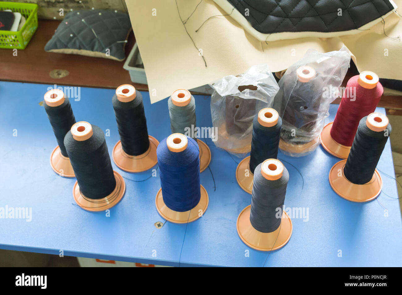 Bobbins with colored threads in the studio Stock Photo