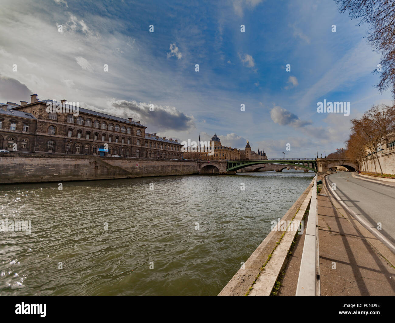 Wide angle view of a walk path along river Seine in Paris France, during a sunny day. Stock Photo