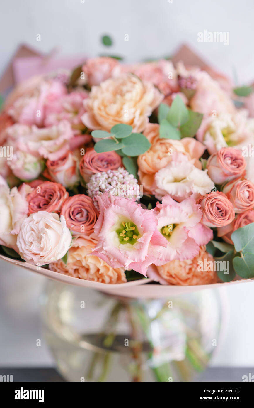 Floristry concept. Bouquet of beautiful flowers on gray table. Spring colors. the work of the florist at a flower shop. Stock Photo