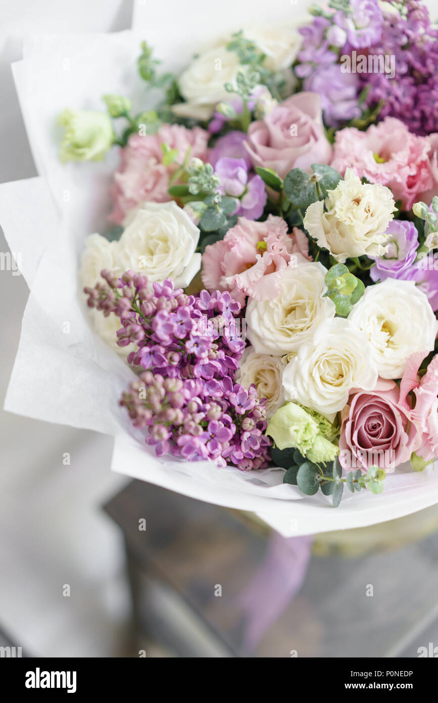 Floristry concept. Bouquet of beautiful flowers on gray table. Spring colors. the work of the florist at a flower shop. Stock Photo