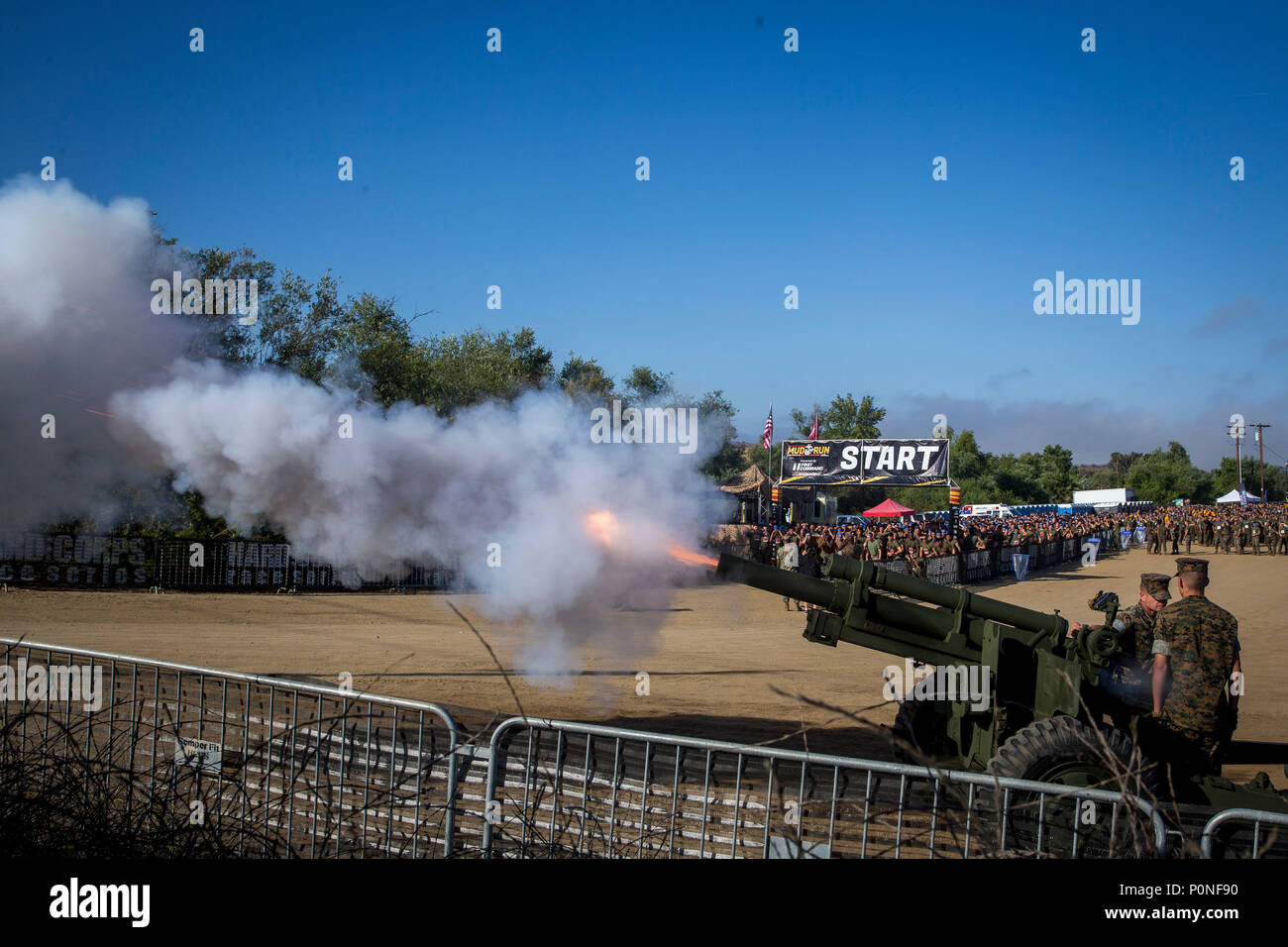 A M105 Howitzer fires, starting the 2018 Mud Run Commanding General’s Cup Team Competition on Marine Corps Base Camp Pendleton, Calif., June 8, 2018. The race stretched over 10-kilometers around Lake O’Neill on MCB Camp Pendleton. Over 2,000 Marines from numerous units around California and neighboring states participated in the challenge. (U.S. Marine Corps photo by Cpl. Juan C. Bustos) Stock Photo
