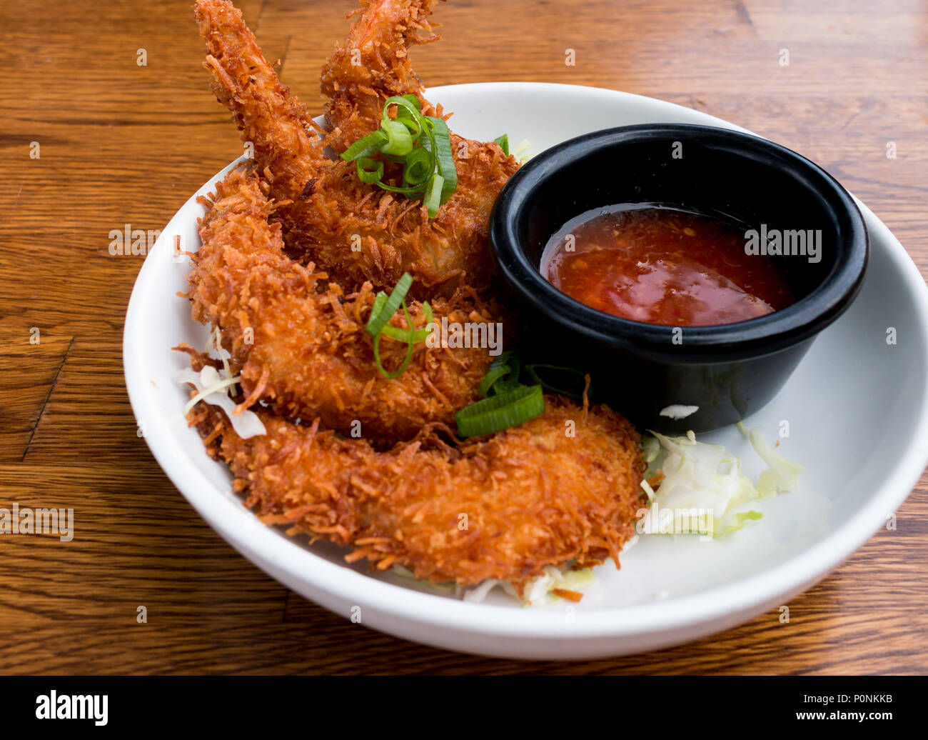 Coconut crusted prawn appetizer served with sweet chili dipping sauce