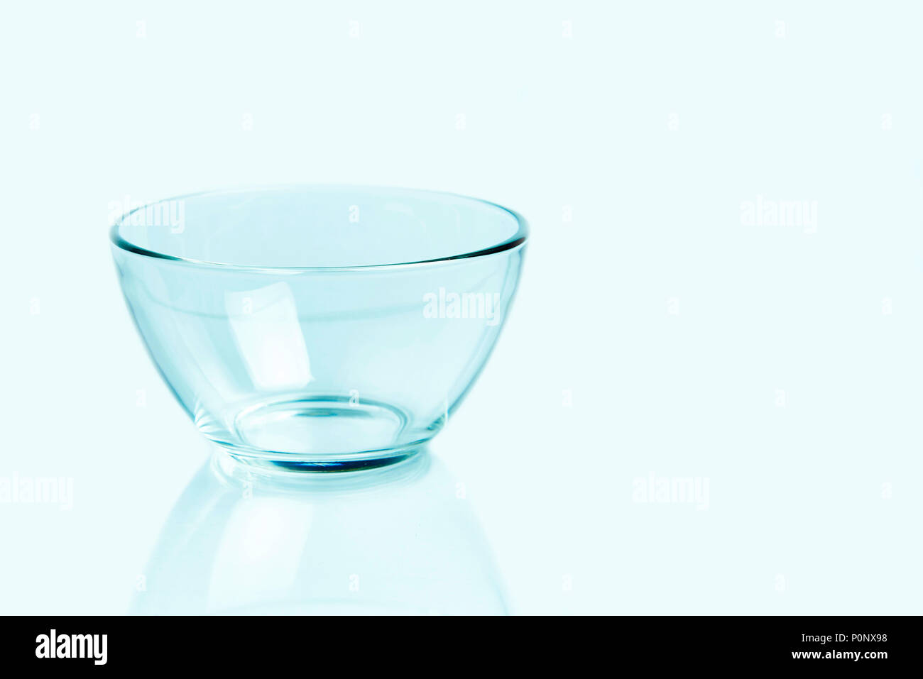 Empty glass bowl on a light background. Copy space. Stock Photo