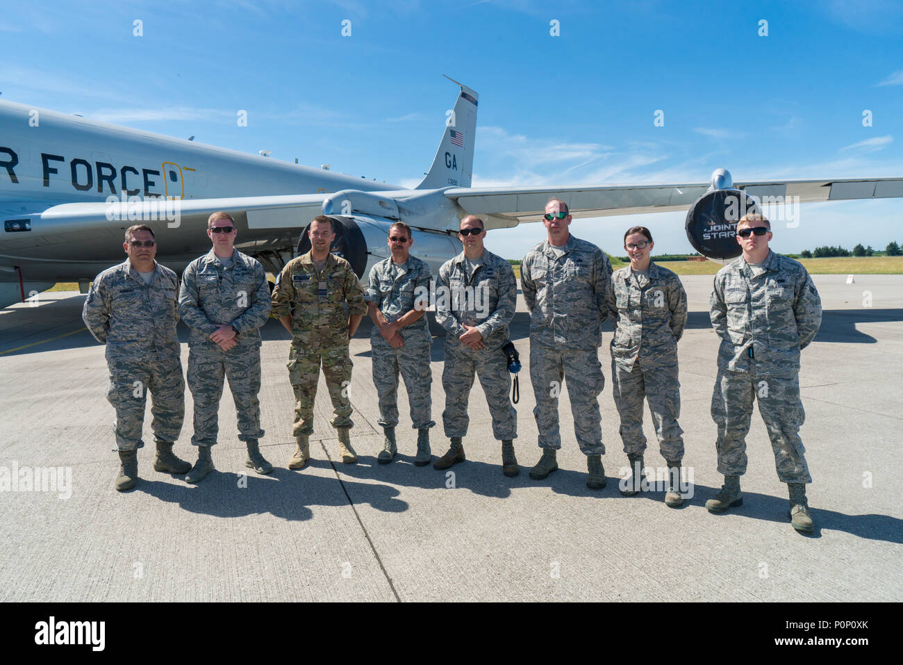 Aircraft maintainers from the 116th Air Control Wing (ACW) and 461st ACW, join Capt. Bo Bojsen, third from left, a Danish aircraft maintenance officer, for a group photo in front of a E-8C Joint STARS at Fighter Wing Skrydstrup, Denmark, June 8, 2018. Bojsen has been instrumental as the liaison between the fighter wing and the JSTARS team. The teamwork demonstrates the interoperability among our units in Europe and cements our ability to assure our allies, respond to threats and ensure support to global operations. The JSTARS team consists of the Georgia Air National Guard’s 116th ACW, plus ac Stock Photo