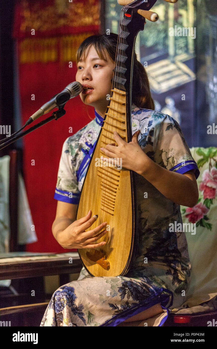 Suzhou, Jiangsu, China.  Young Woman Playing a Pipa. Stock Photo