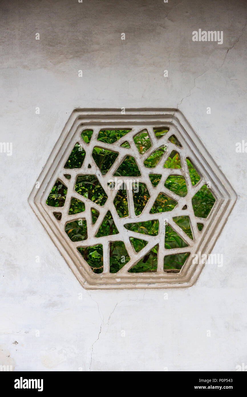 Suzhou, Jiangsu, China.  Hexagonal Window in Garden Wall, House of the Master of the Nets. Stock Photo