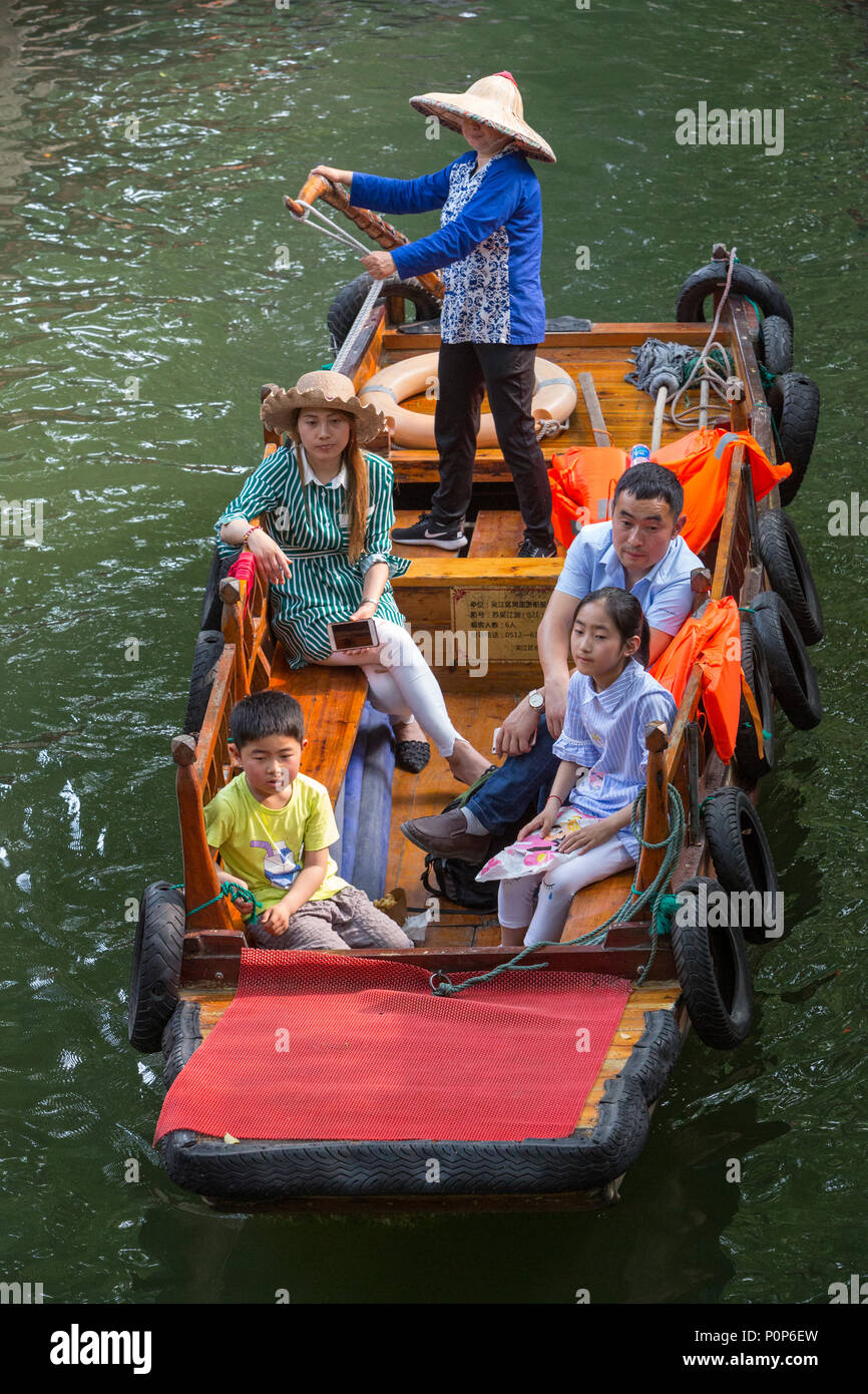 Suzhou, Jiangsu, China.  Chinese Family Taking Boat Ride on a Canal in Tongli Ancient Town near Suzhou. Stock Photo
