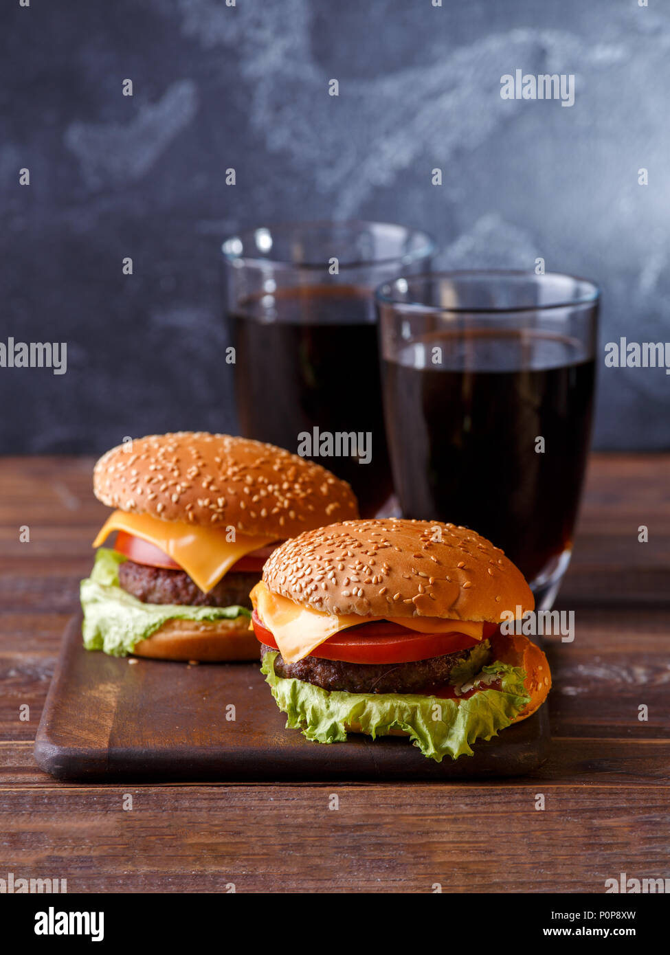 Image of two fresh hamburgers and two glasses of juice Stock Photo