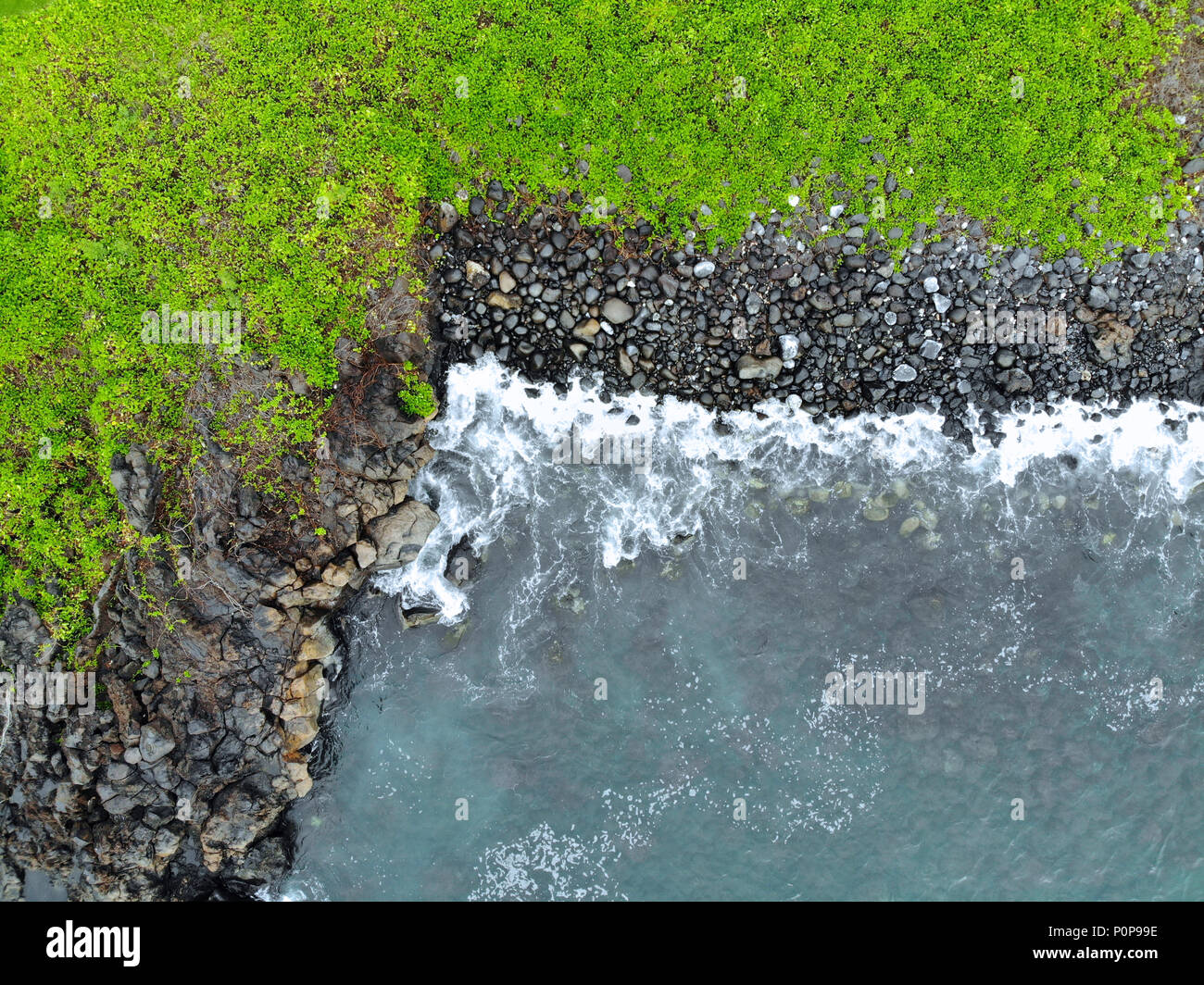 Aerial view of a black volcanic rock beach and ocean in Wailea, Maui, Hawaii Stock Photo