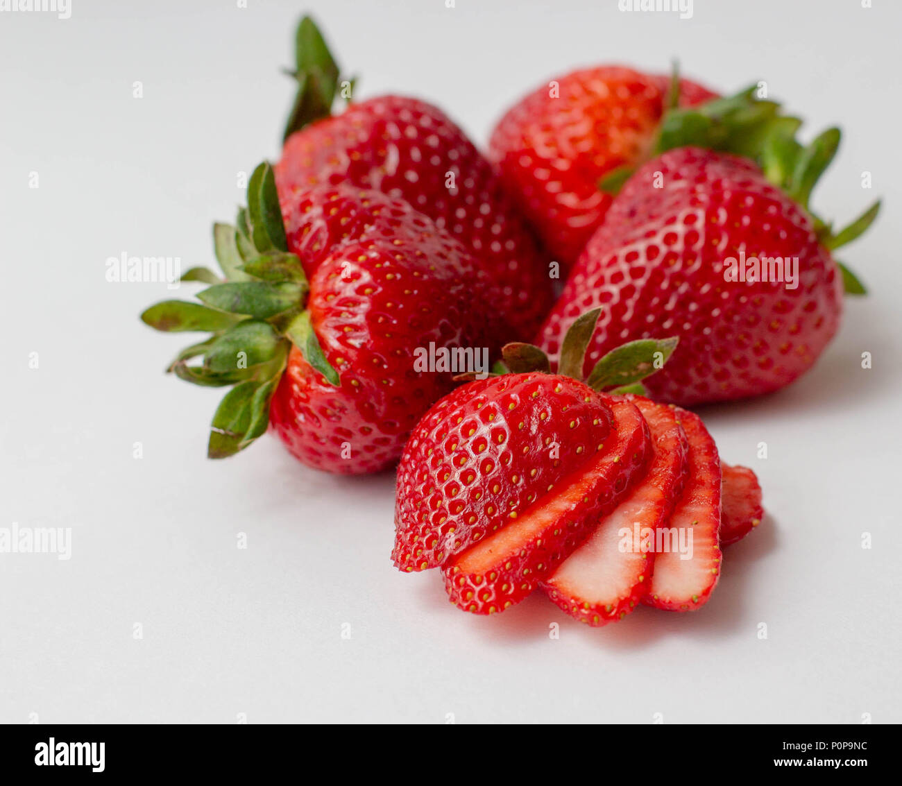 Whole and sliced strawberries on white background Stock Photo Alamy