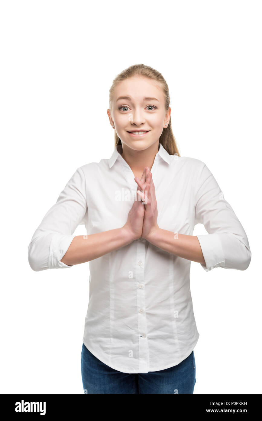 emotional caucasian teenage girl holding hands together and looking at ...