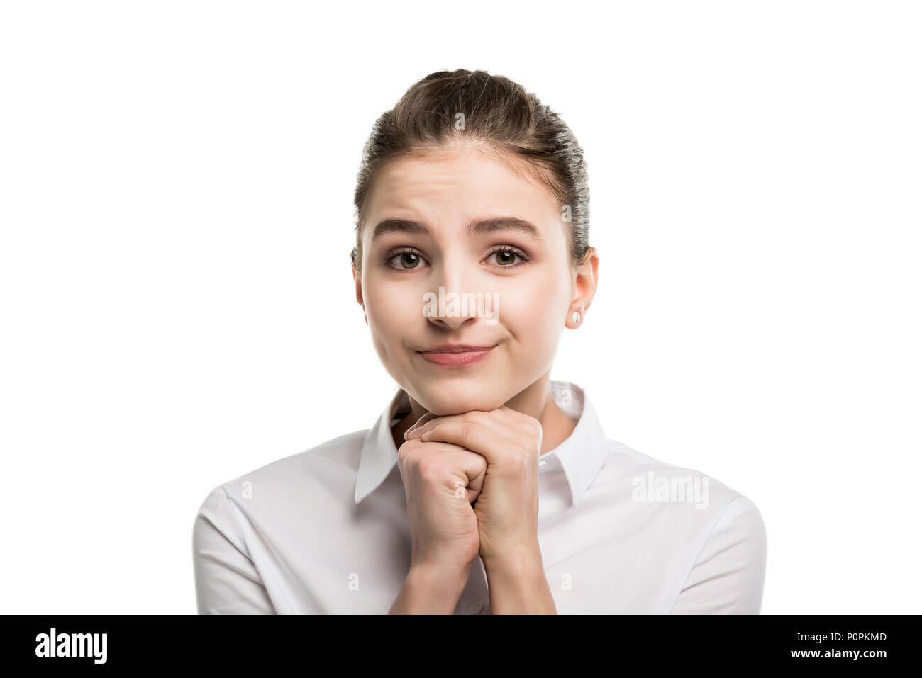 portrait of cute caucasian teenage girl holding hands together and ...