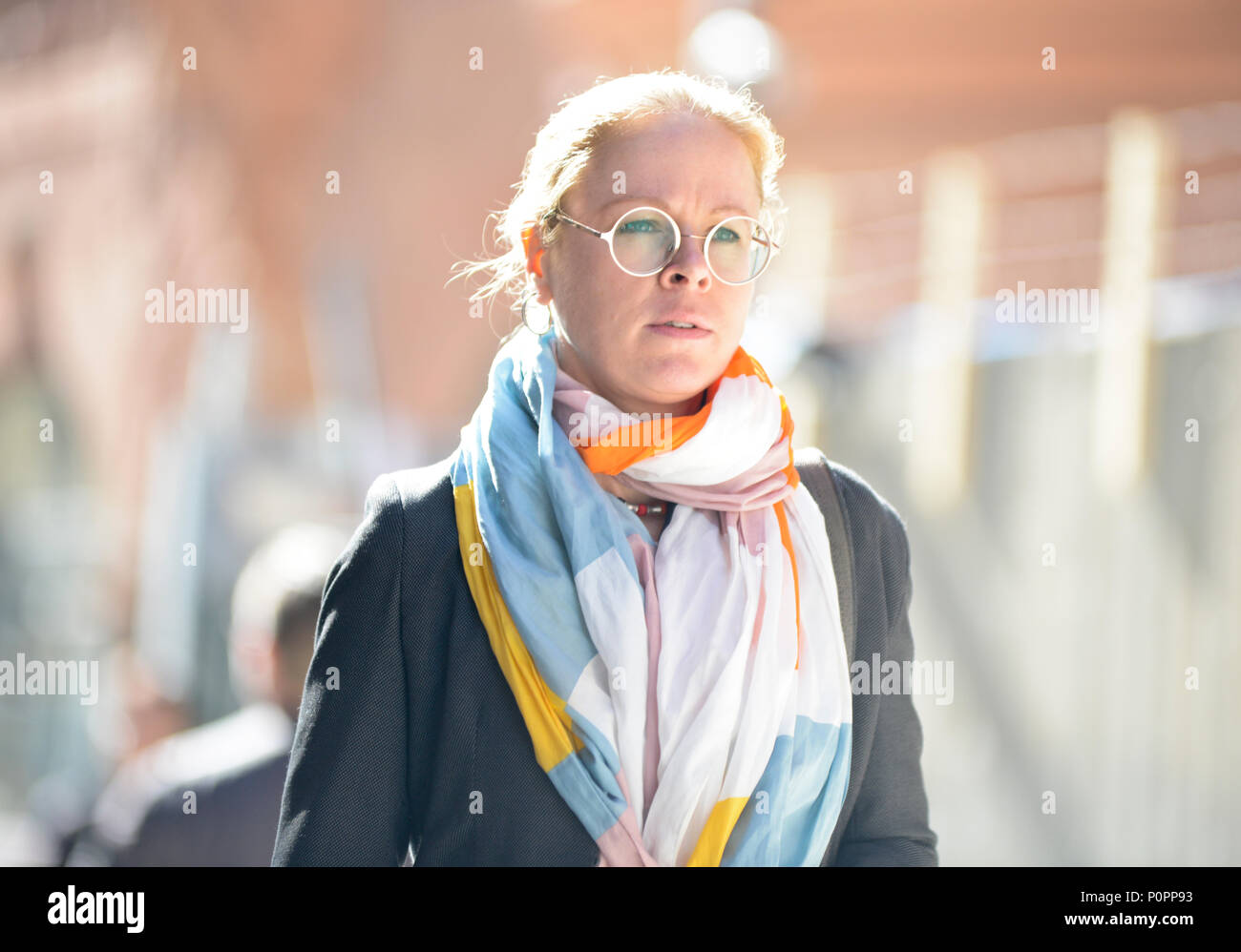 Blonde swedish woman walking in Drottninggatan street, Stockholm Stock Photo