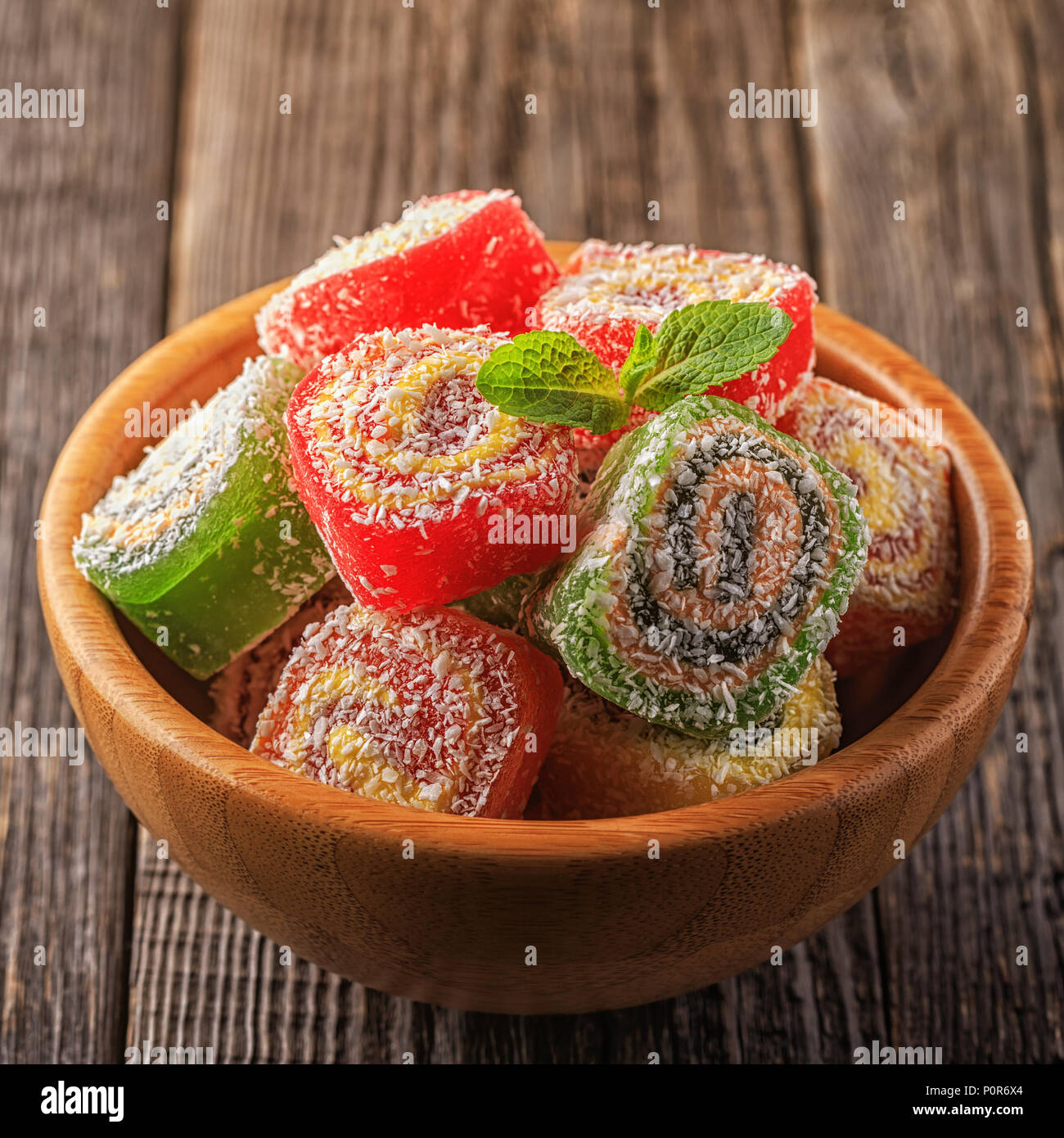 Turkish delight on dark wooden background,  selective focus. Stock Photo