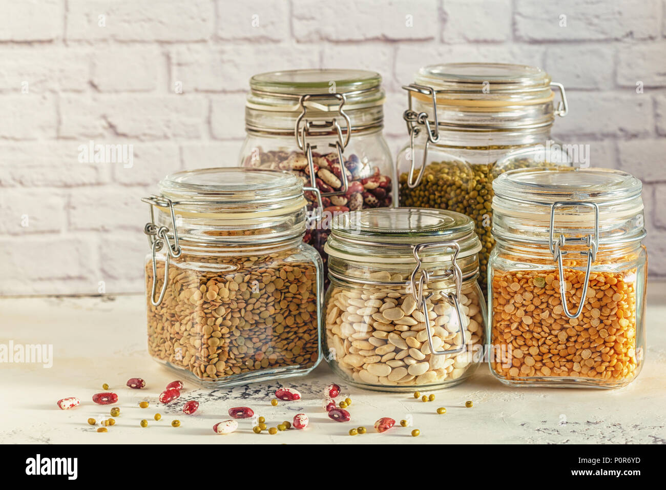 Glass jars with various legumes beans, mung bean, peas and lentils