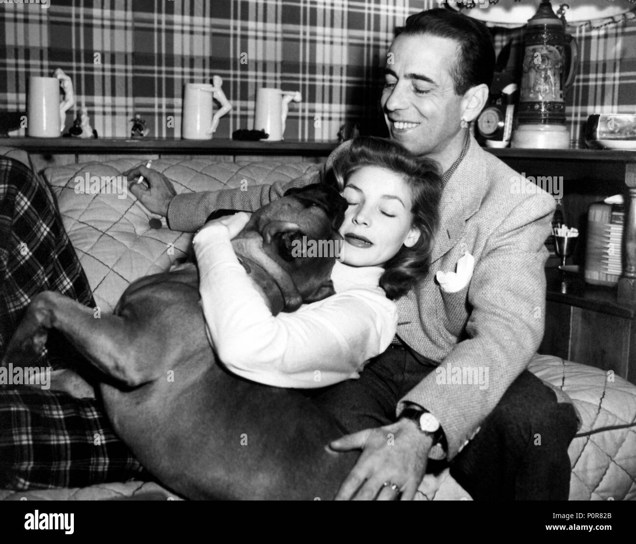 Description: Lauren Bacall and Humphrey Bogart with their dog Harvey.  Stars: LAUREN BACALL; HUMPHREY BOGART. Stock Photo