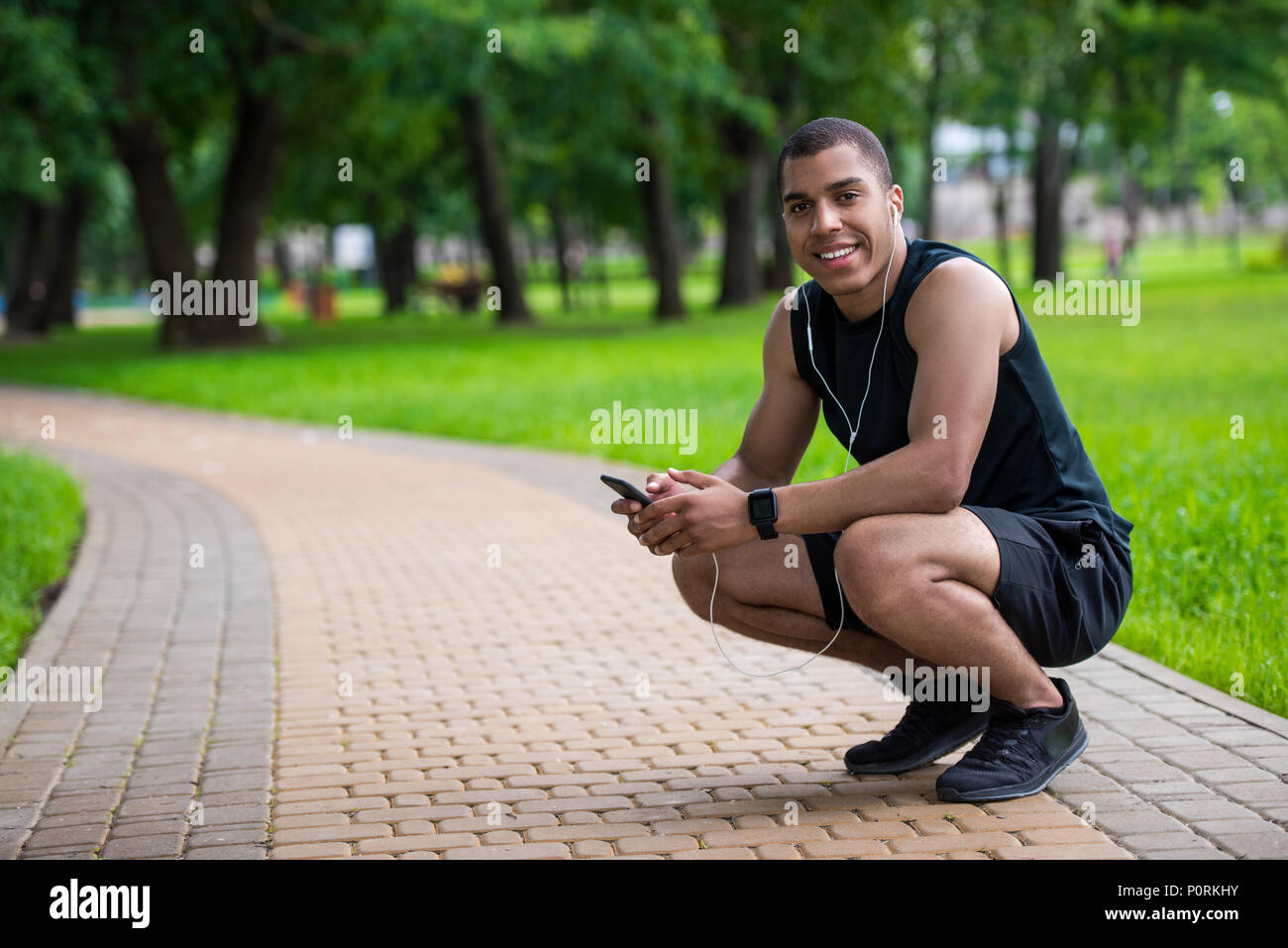Smiling african american sportsman using hi-res stock photography and ...