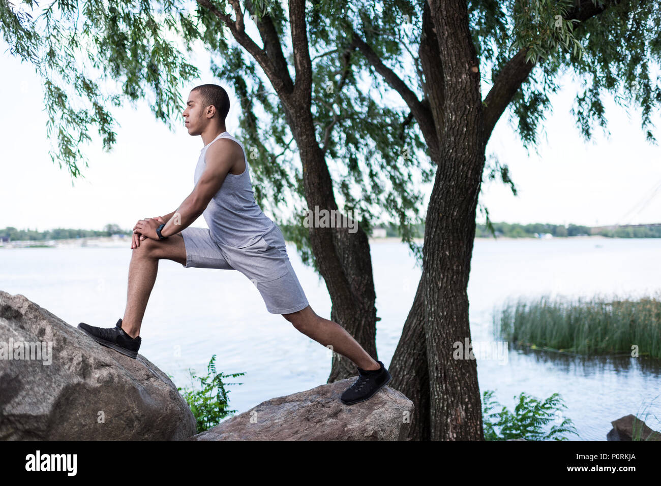 Man stretching by the riverside hi-res stock photography and images - Alamy