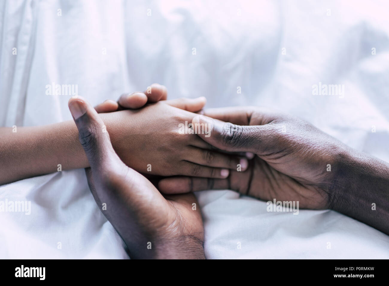partial view of african american father and son holding hands together ...
