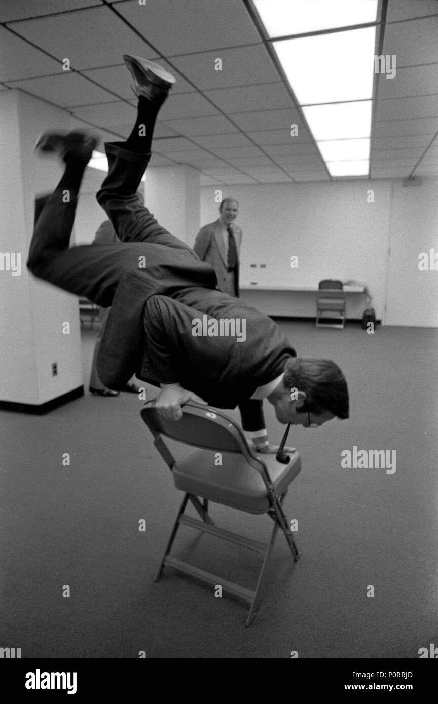 1974, October 22 – Myriad Convention Center – Oklahoma City, OK – Donald Rumsfeld – doing handstand on chair – Prior to Rally for Oklahoma Campaign Workers - Oklahoma City, Oklahoma Stock Photo