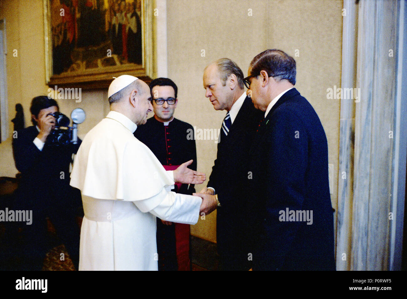 Pope Paul VI greets President Ford in the Vatican’s Papal Library.  Vatican City, Rome, Italy.  June 3, 1975.  Also present is Bishop Jacques Martin. Stock Photo