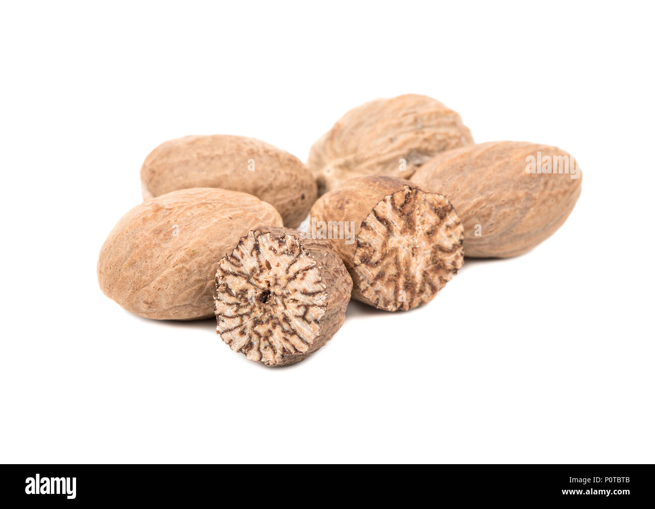 Dry nutmeg with half isolated on white background Stock Photo - Alamy