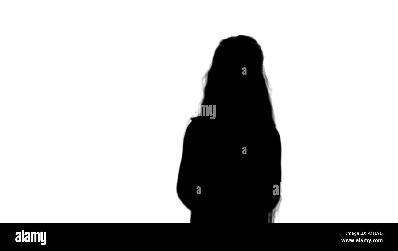 Silhouette Positive teen girl talking to a camera with a smile track matte Stock Photo