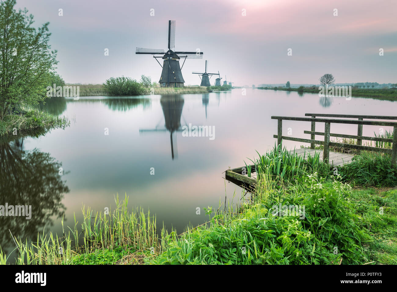 Windmill reflected in the canal Kinderdijk Rotterdam South Holland Netherland Europe Stock Photo