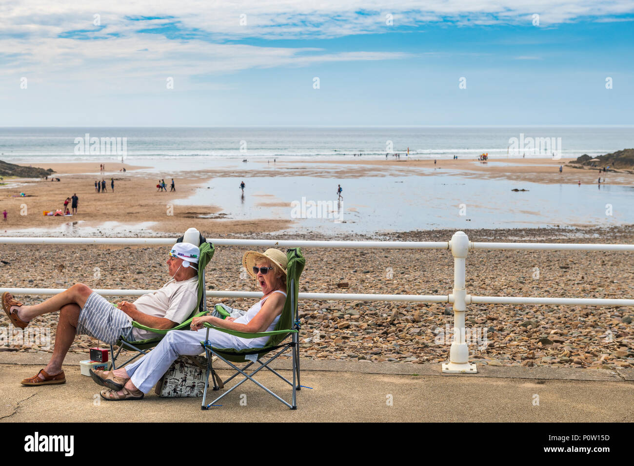 A couple enjoy the excitement of being on holiday in the popular North Cornwall resort of Bude. Stock Photo