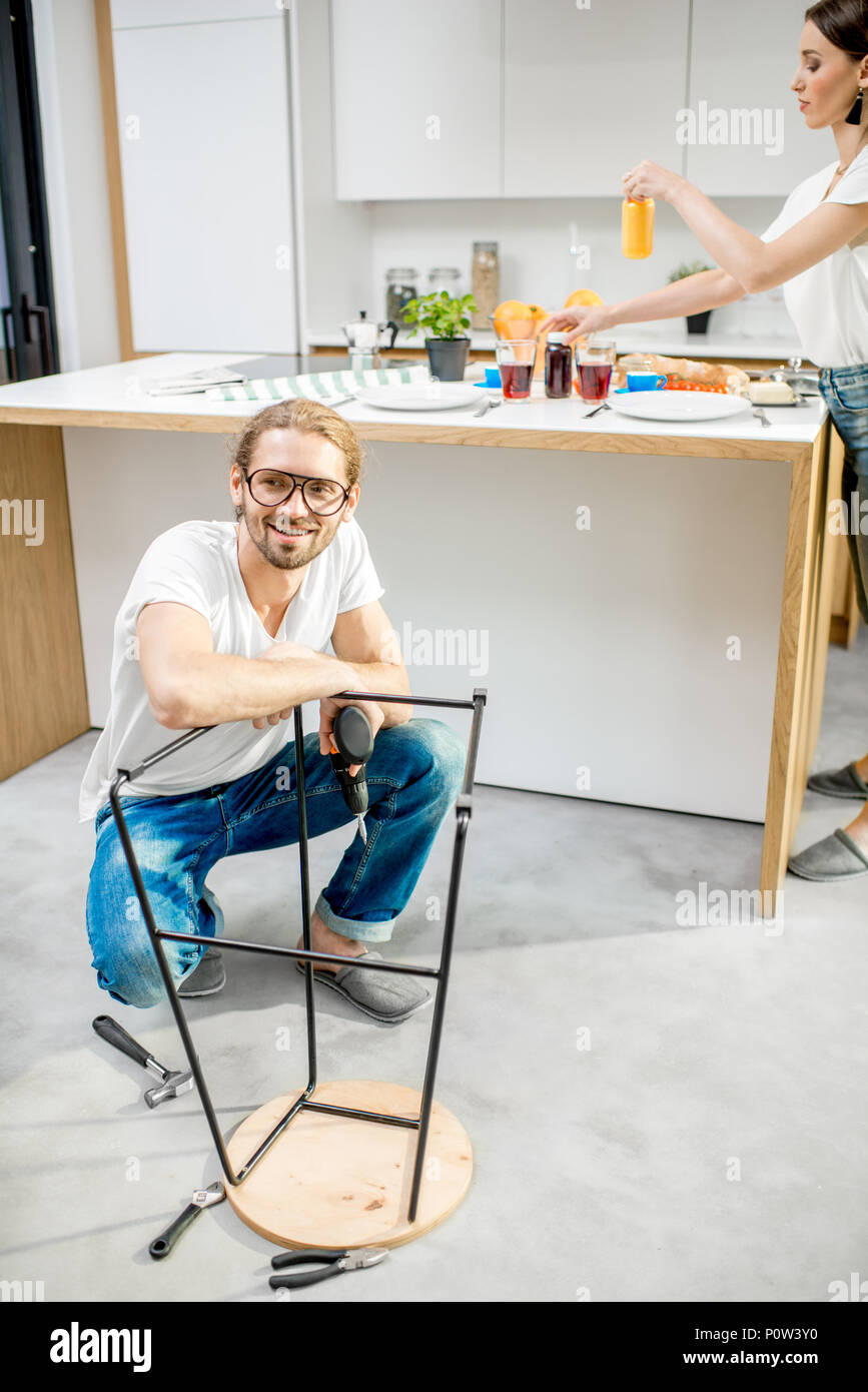 Man assembling chair in the apartment Stock Photo