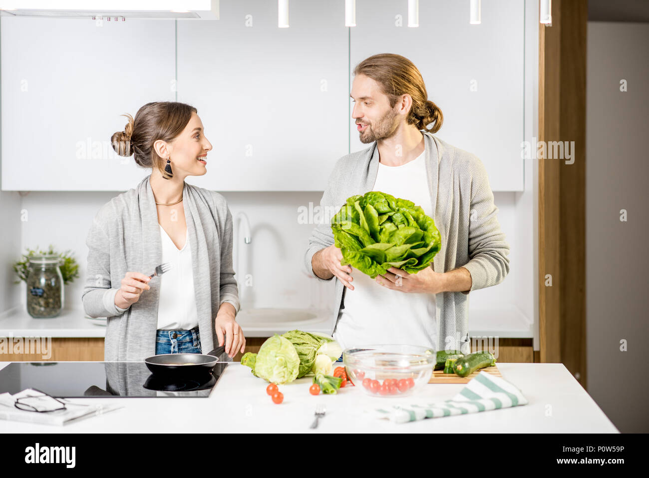 Couple cooking food at the kitchen home Stock Photo