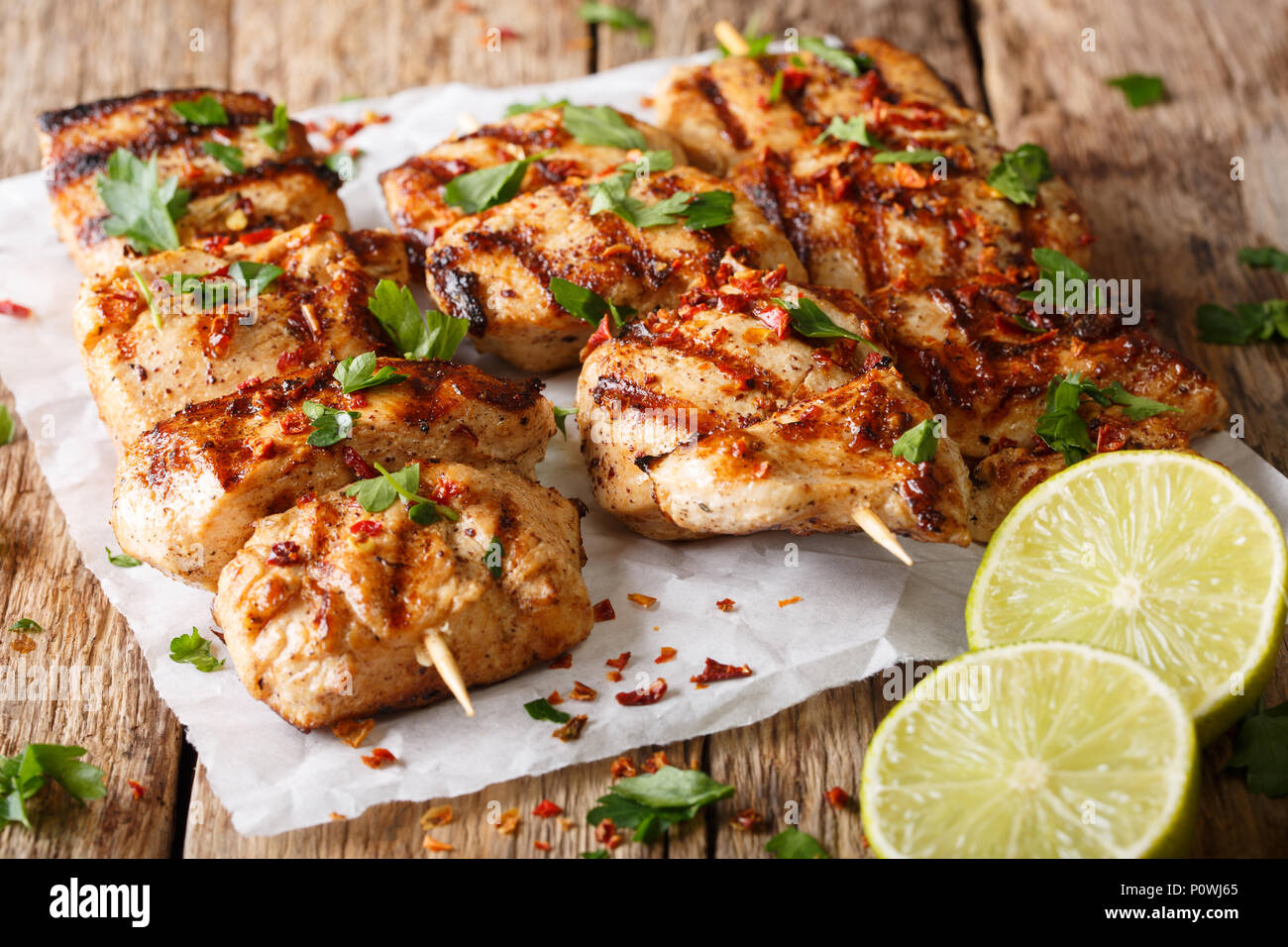 Afghanistan's barbecue: grilled chicken skewers Kebab e Murgh close-up on paper on a table. horizontal Stock Photo