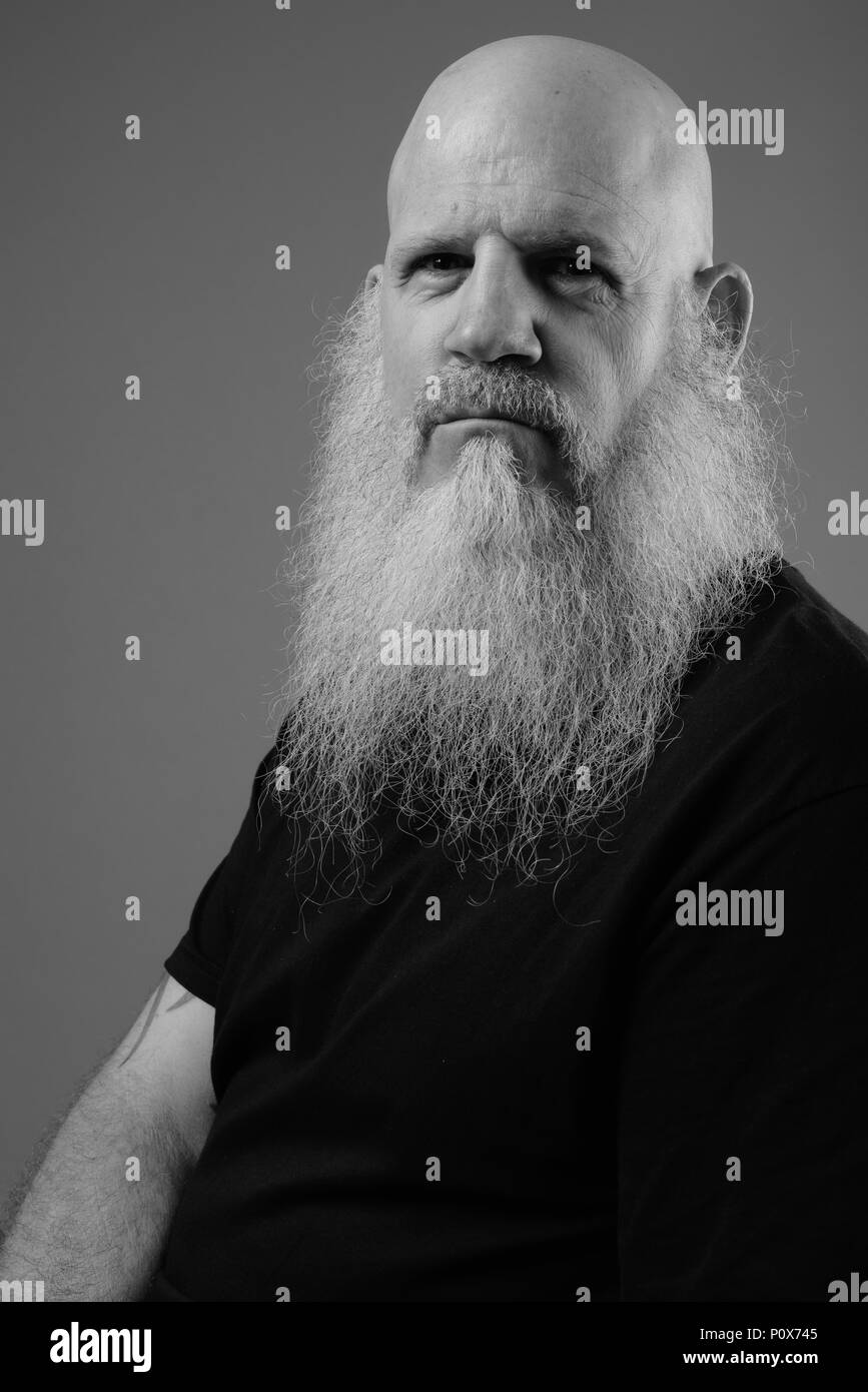Black And White Portrait Of Mature Bald Man With Long Beard Stock Photo
