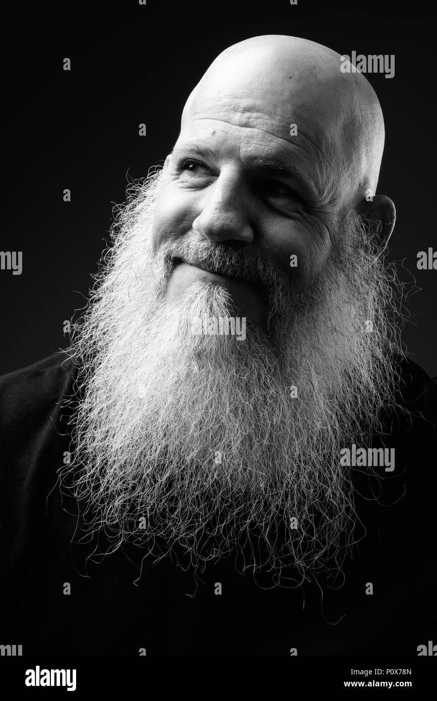 Black And White Portrait Of Mature Bald Man With Long Beard Stock Photo
