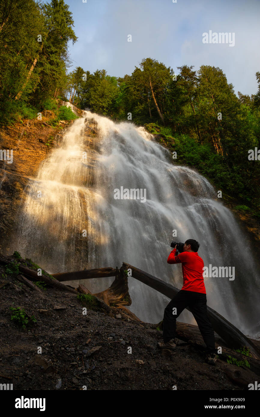 Man enjoying the beautiful waterfall. Taken in Bridal Veil Falls Provincial Park near Chilliwack, East of Vancouver, British Columbia, Canada. Stock Photo