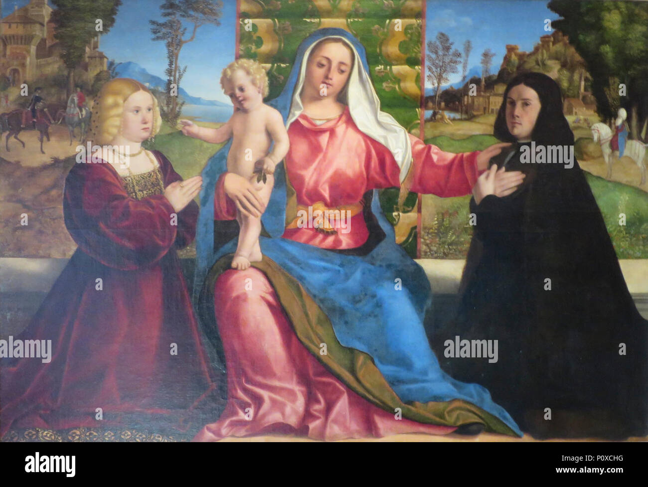 'Madonna and Child with Donors' by Jacopo Palma Vecchio (Palma il Vecchio), Hermitage. Stock Photo