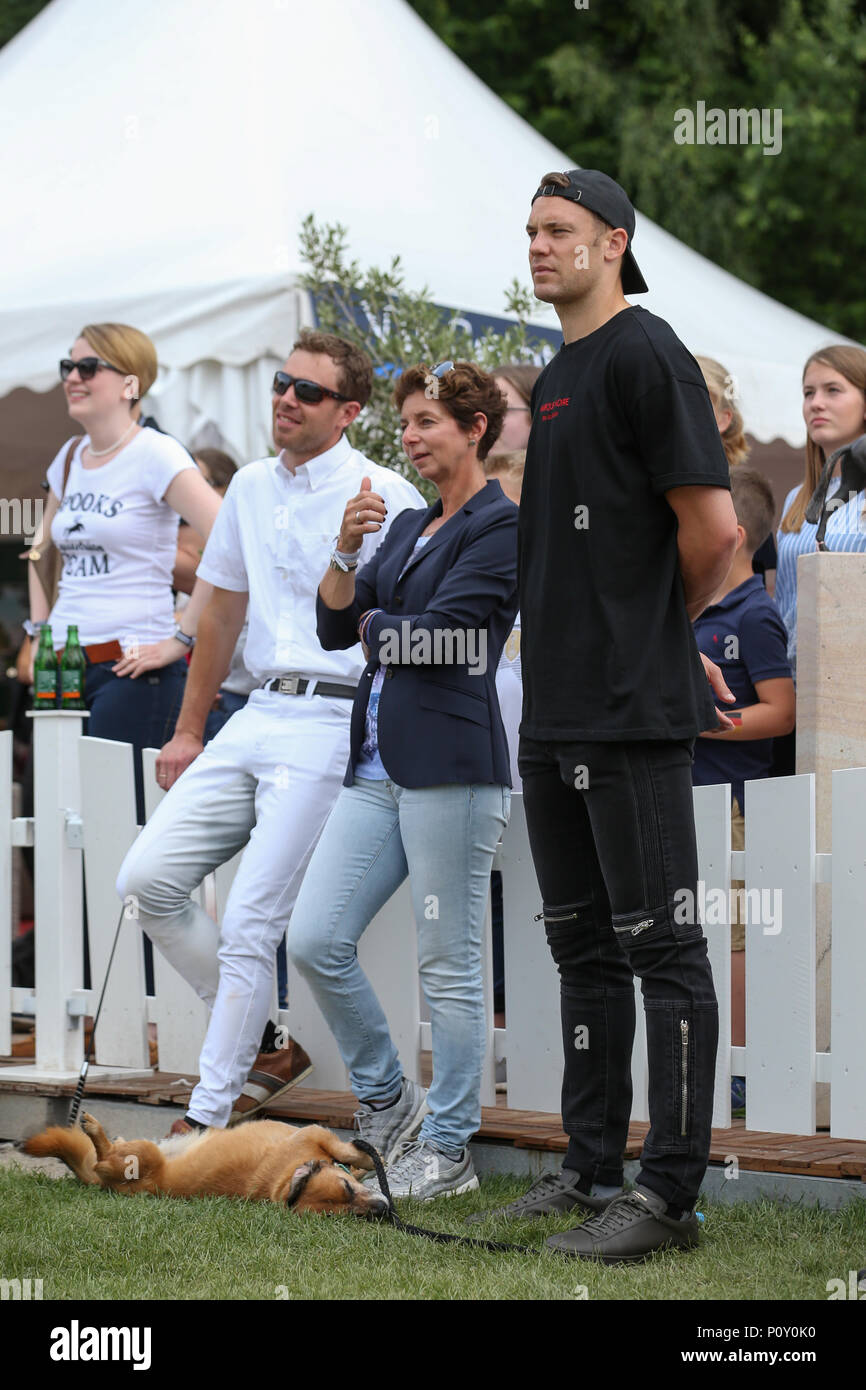 10 June 2018, Balve, Germany: Dressage coach Benjamin Werndl (L-R), Monica Theodorescu, federal trainer for dressage riding and soccer national goalkeeper Manuel Neuer watch the performance of Neuer's wife Nina Neuer, who is competing in the Grand Prix U25 with horse Don Darius. Photo: Friso Gentsch/dpa Stock Photo