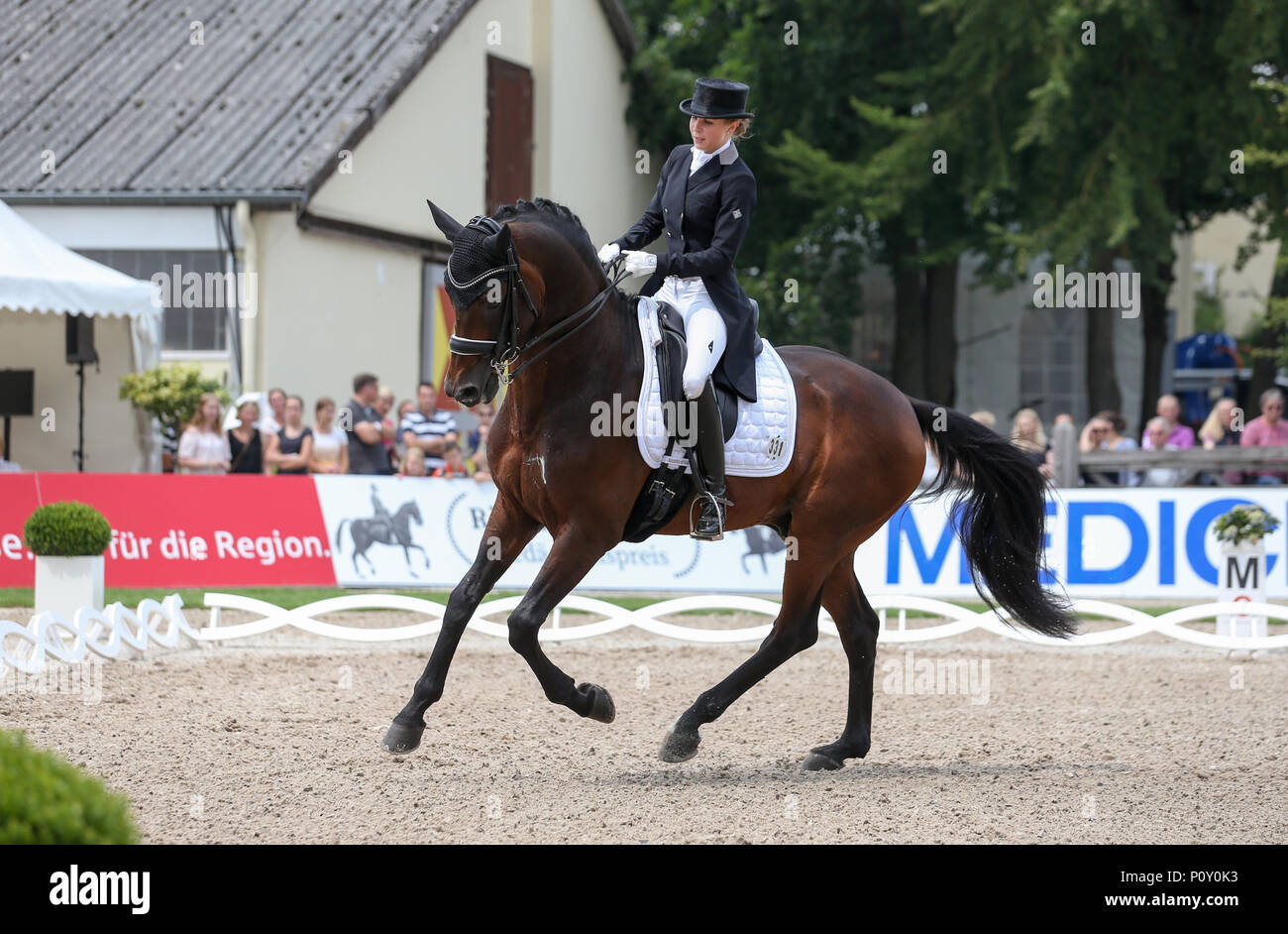 10 June 2018, Balve, Germany: Nina Neuer, equestrian athlete coincidentally married to soccer national team goalkeeper Manuel Neuer competes in the Grand Prix U25 with horse Don Darius. Photo: Friso Gentsch/dpa Stock Photo