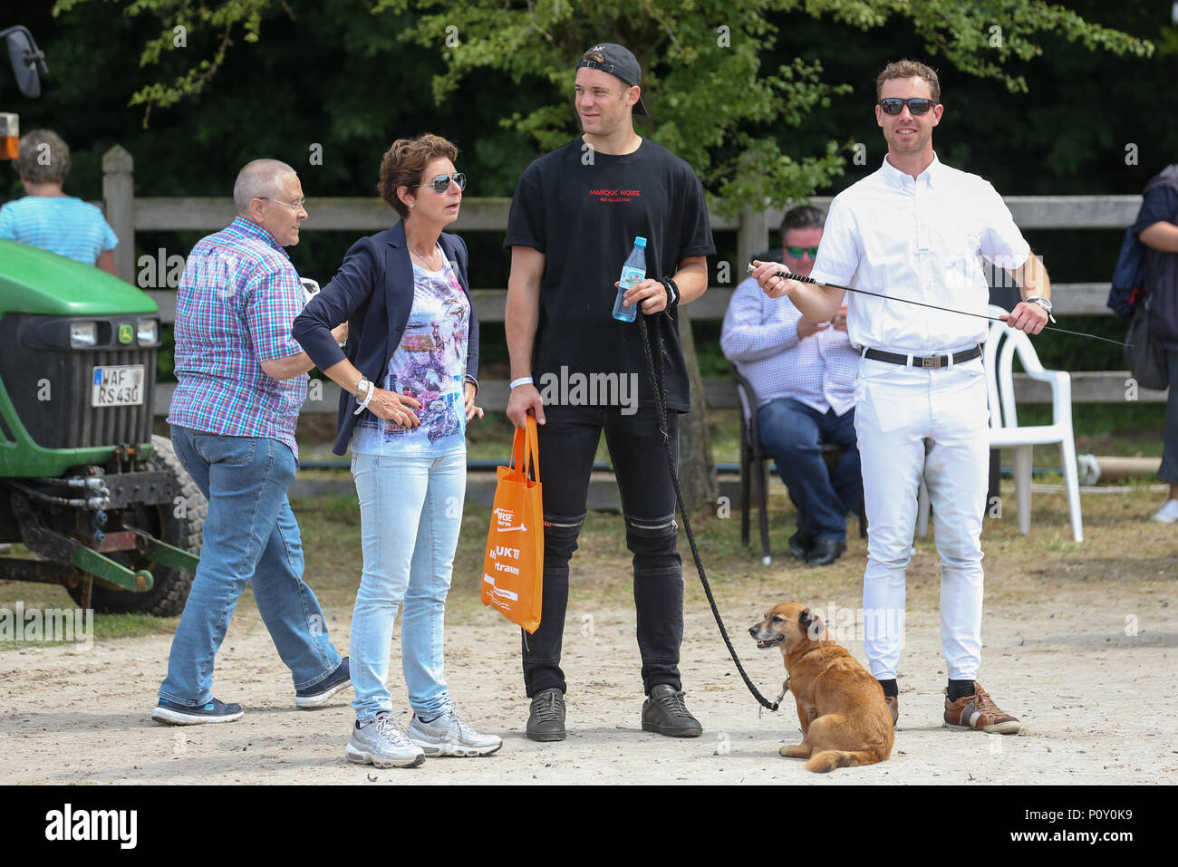 10 June 2018, Balve, Germany: Dressage coach Benjamin Werndl (R), Monica Theodorescu, federal trainer for dressage riding and soccer national goalkeeper Manuel Neuer (C) watch the performance of Neuer's wife Nina Neuer, who is competing in the Grand Prix U25 with horse Don Darius. Photo: Friso Gentsch/dpa Stock Photo